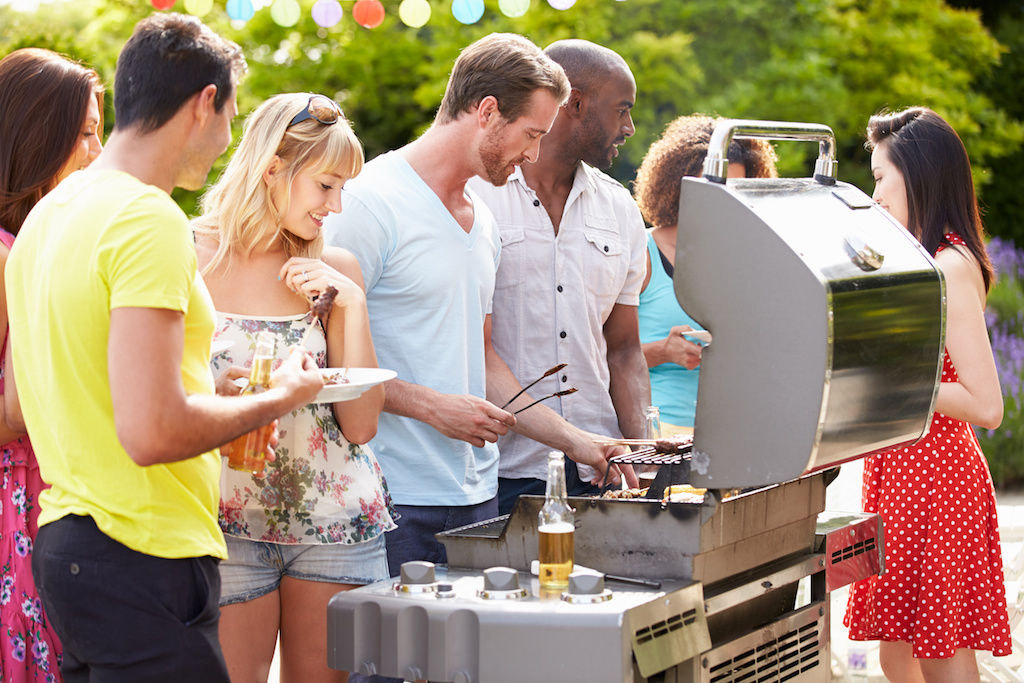 Group of friends around a grill